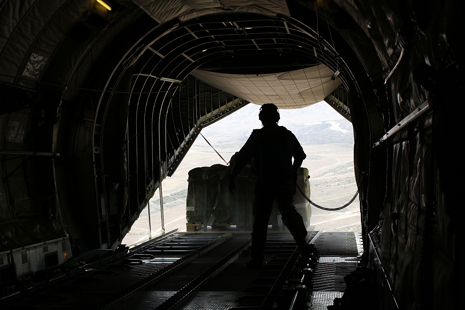 Cargo is dropped out of a C160 during the flight